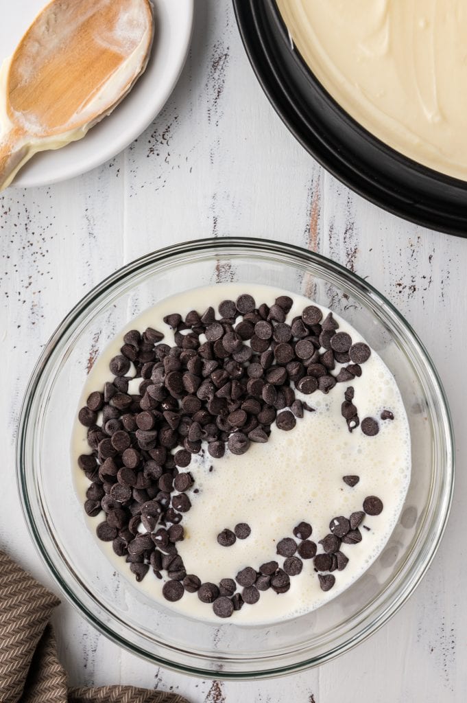 heavy cream and chocolate chips in a bowl to melt for ganache