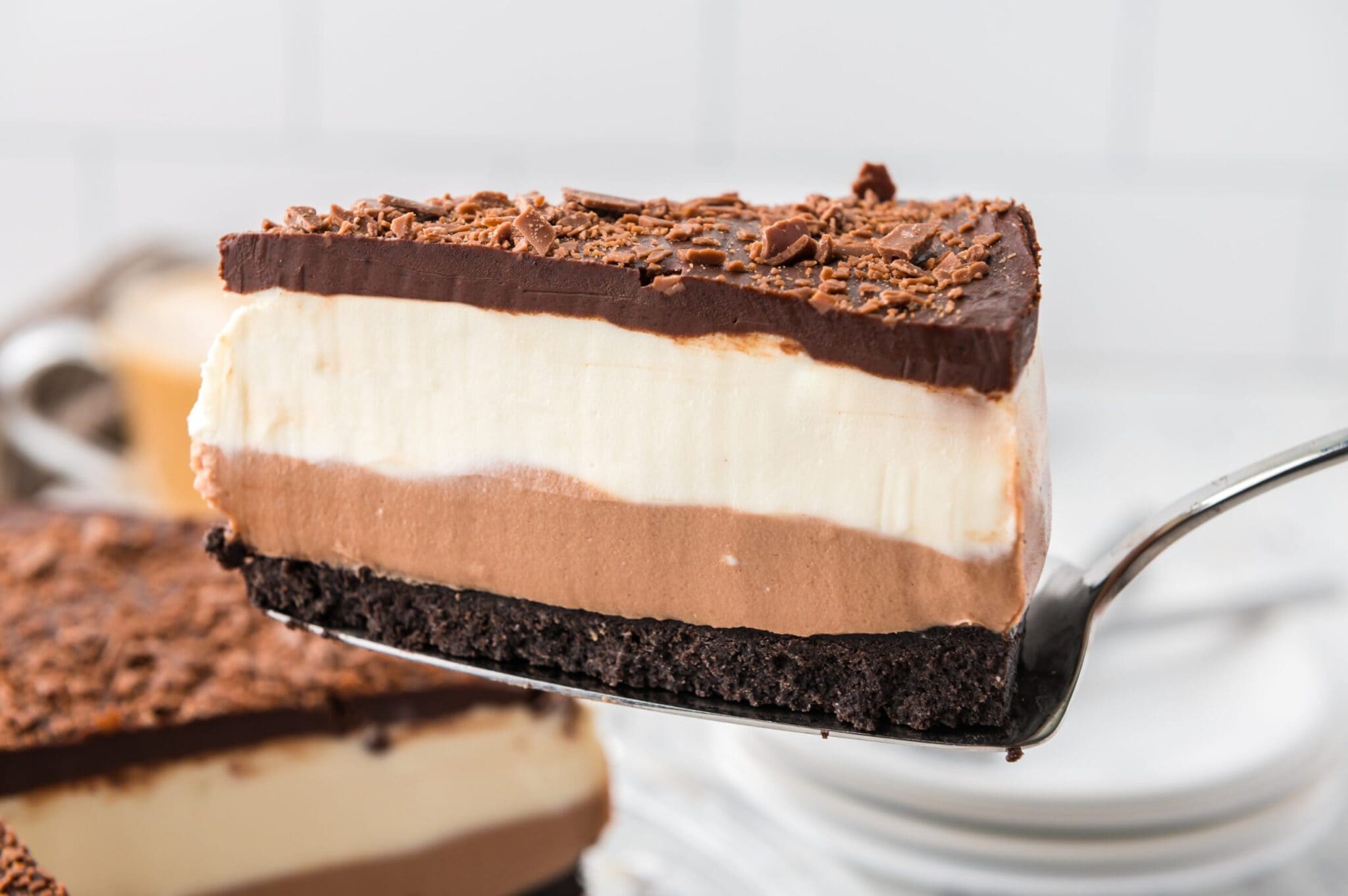 Up close of a triple layered Chocolate Cheesecake 