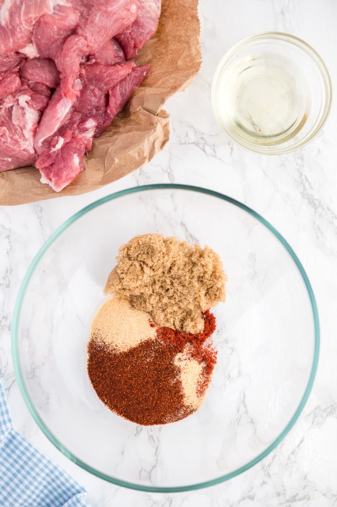 all the spices in a bowl to mix together to make a homemade rub for the instant pot pulled pork