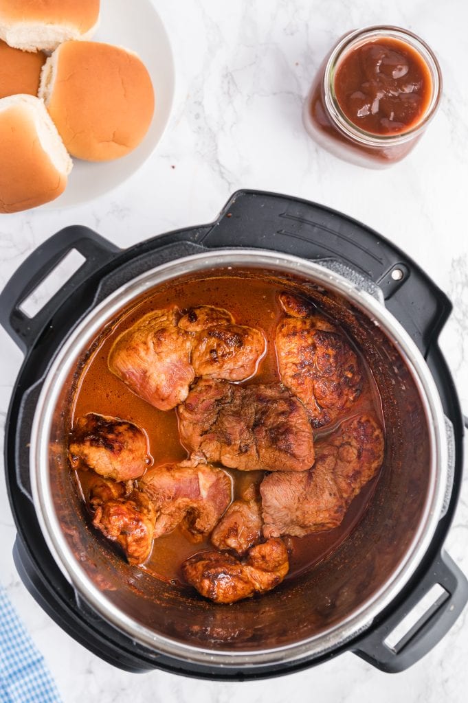 pork in the instant pot covered with chicken broth