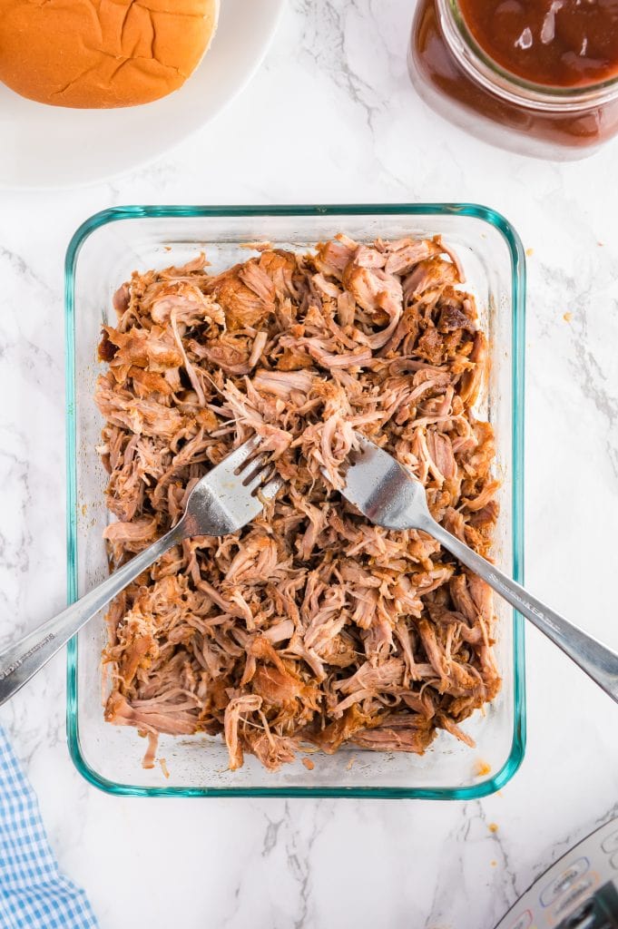 Shredding pulled pork with two forks