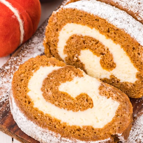 A pumpkin roll with a swirl of cream cheese filling.