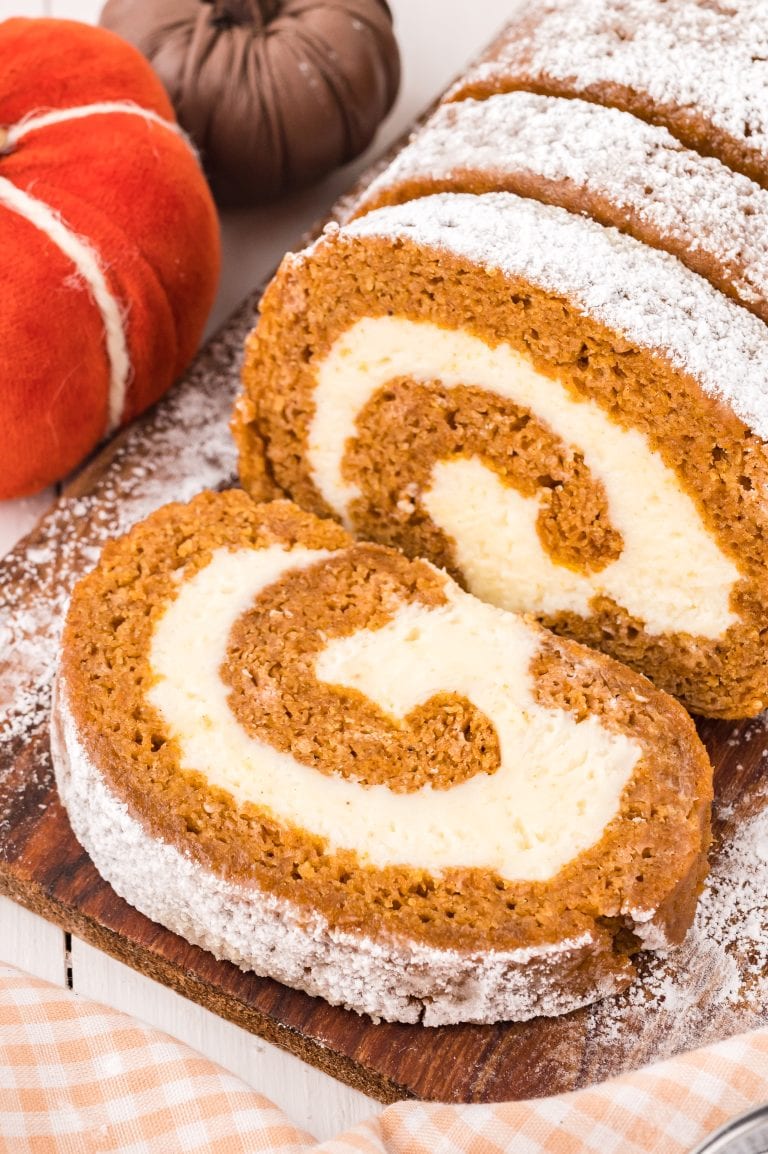 A pumpkin roll with a swirl of cream cheese filling.