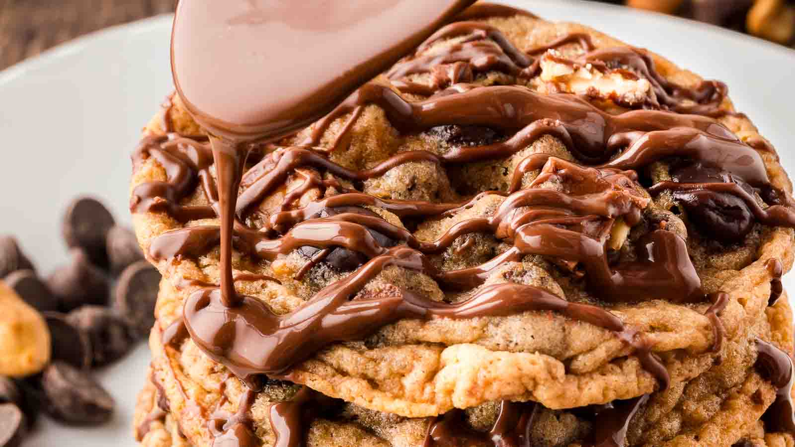 up close picture of chocolate being drizzled over cookies