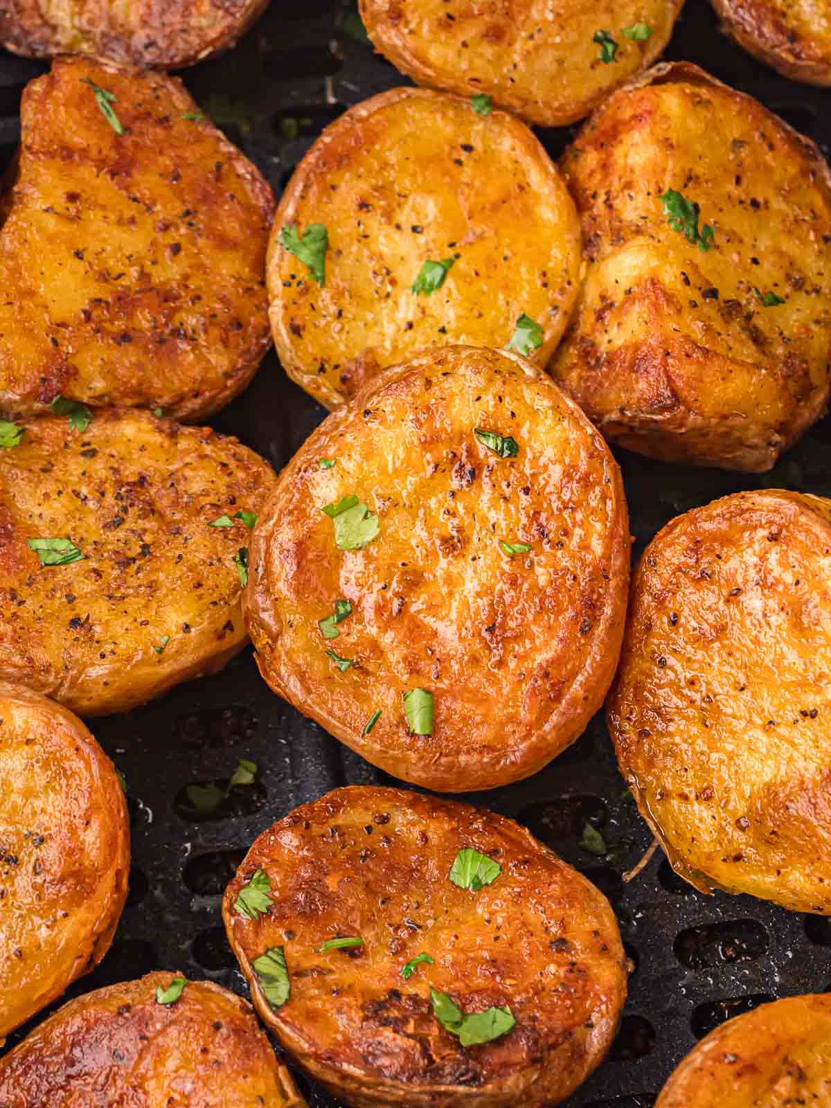 Air Fried Roast Potatoes inside an air fryer.