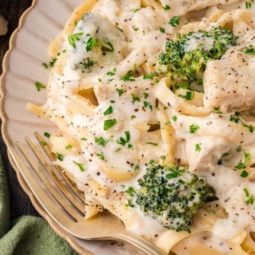 Chicken and Broccoli Alfredo on a plate with a gold fork.