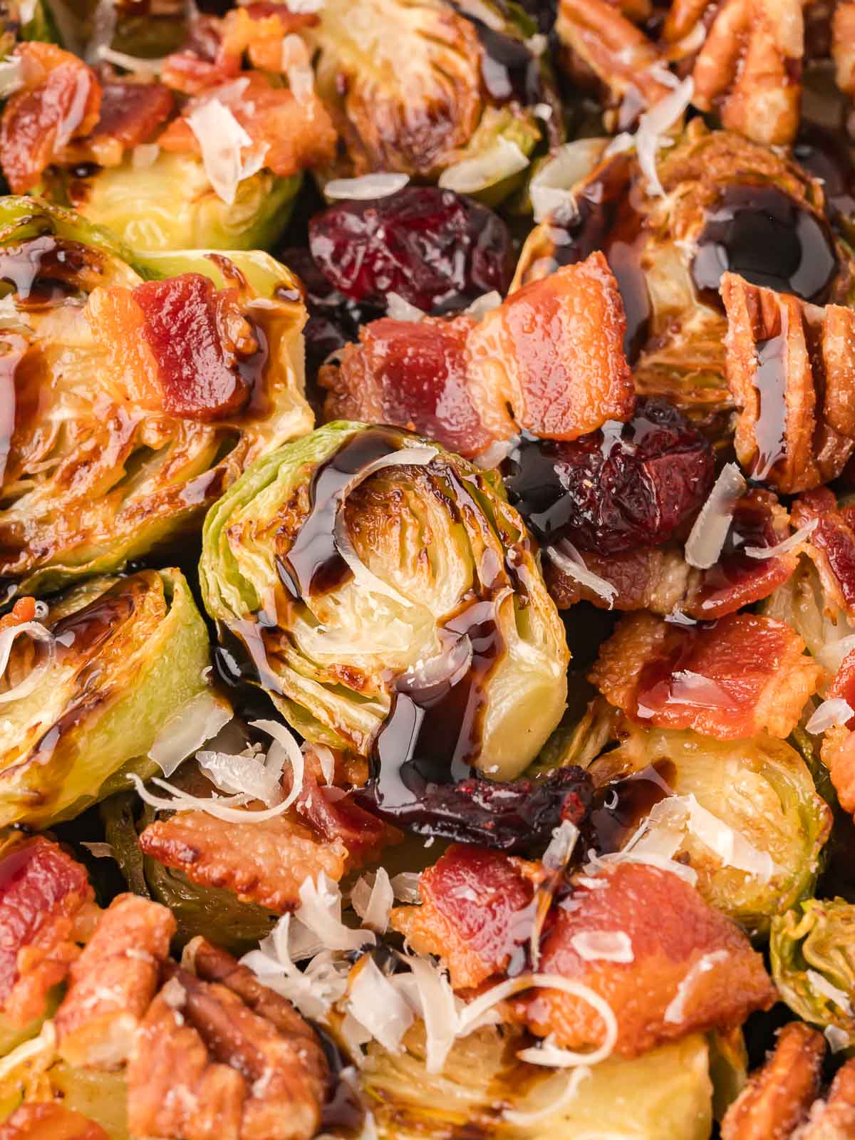 Up close of Warm Brussels Sprout Salad with balsamic glaze.