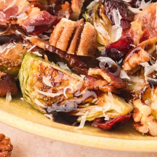 Up close of Warm Brussels Sprout Salad with balsamic glaze.