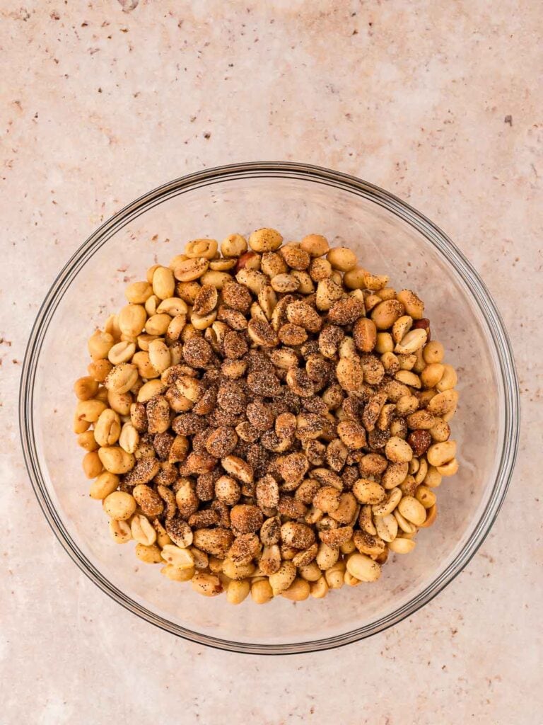 A bowl with peanuts and spiced in it.