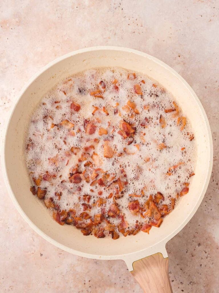 Bacon cooking in a pan.