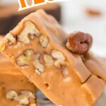 A slice of butterscotch fudge with whole pecans peeking through, giving a perfect preview of its rich and nutty texture.