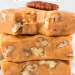 A slice of butterscotch fudge with whole pecans peeking through, giving a perfect preview of its rich and nutty texture.