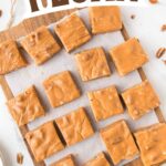 A slice of butterscotch fudge with whole pecans peeking through, giving a perfect preview of its rich and nutty texture.