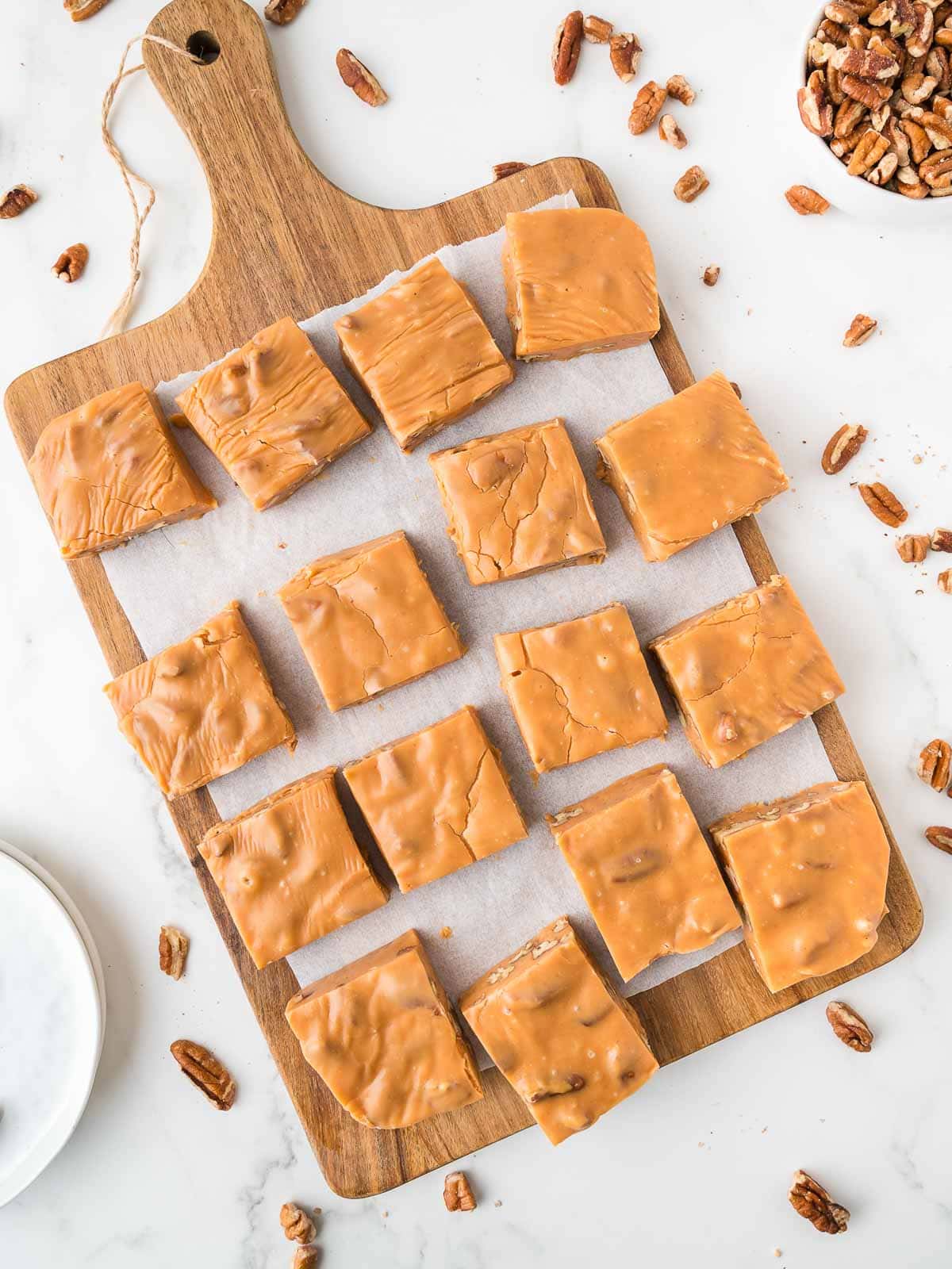 butterscotch pecan fudge on a wooden board.