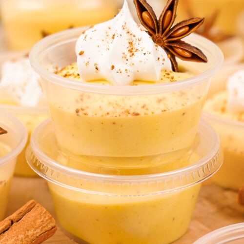 A stack of two Eggnog Pudding Shots in a pudding cup.