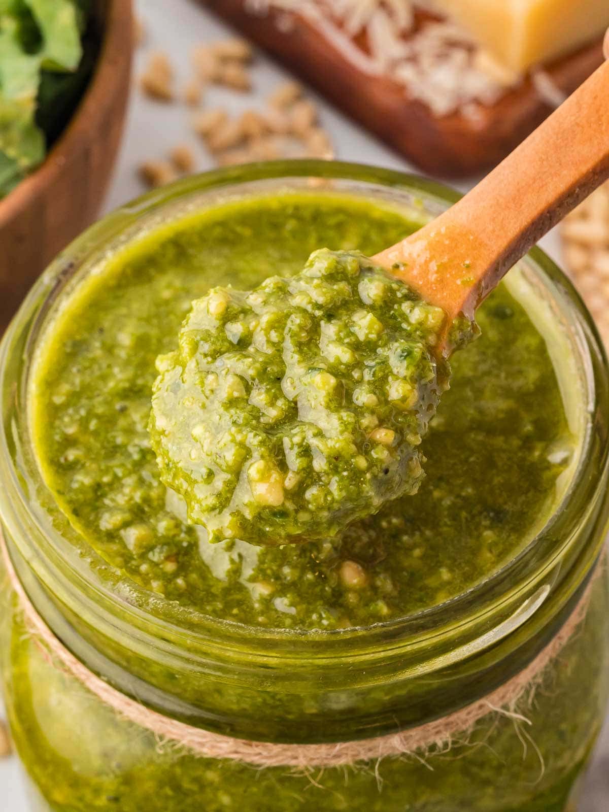 Up close of Kale Pesto on a wooden spoon.