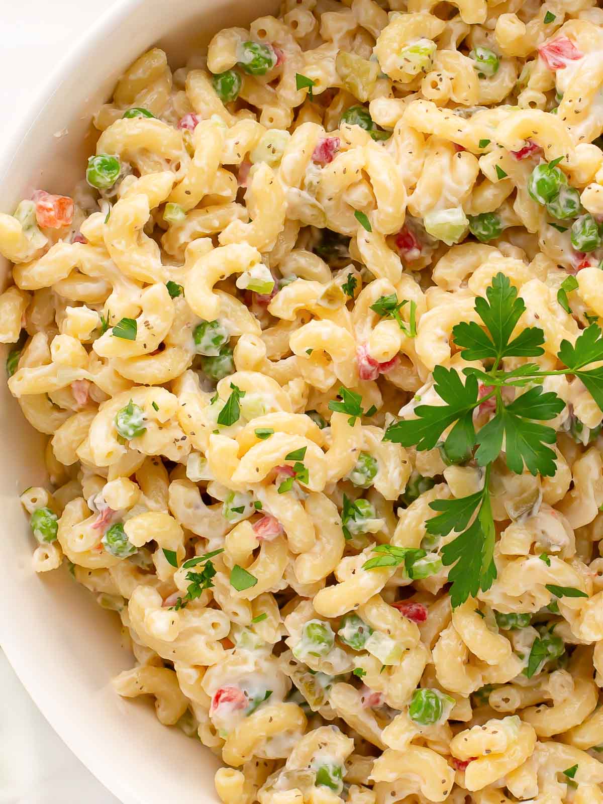 Up close of Macaroni Salad in a white bowl.