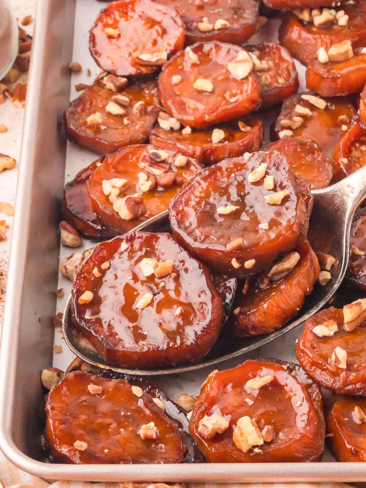 Up close of Maple Roasted Sweet Potatoes on a serving spoon.