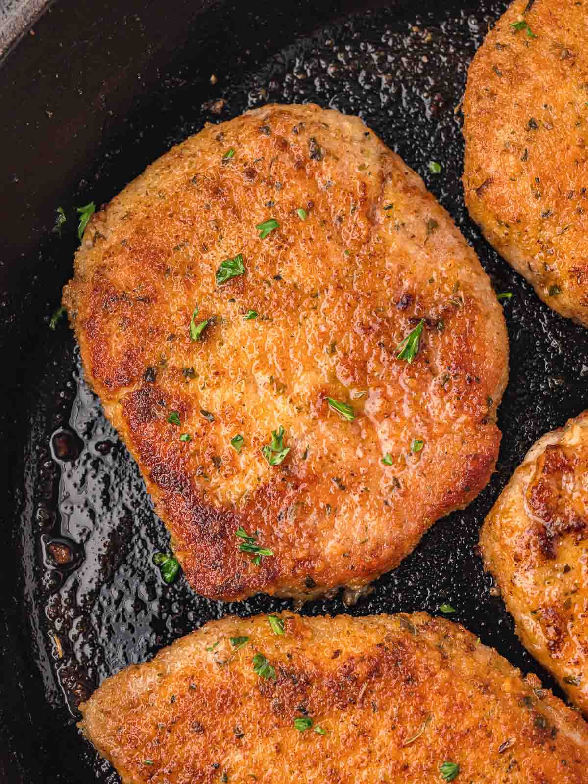 Parmesan Crusted Pork Chop in a pan.