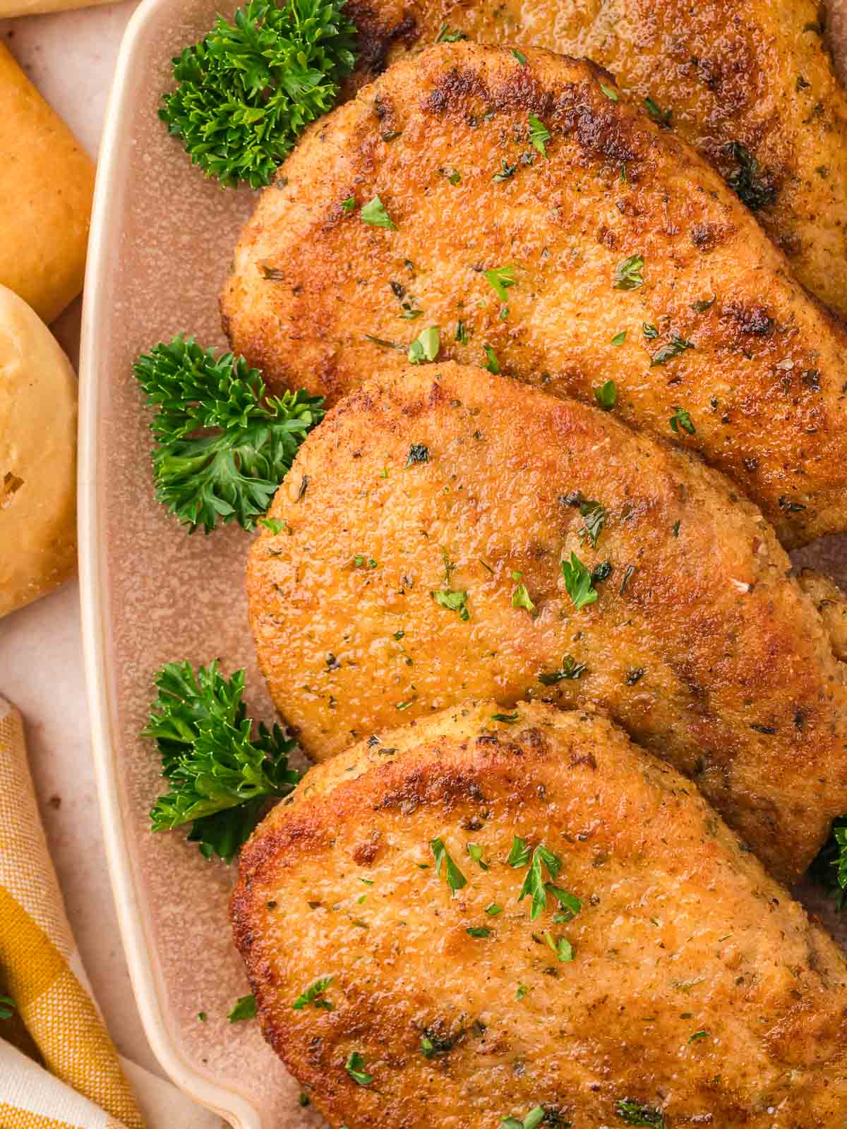 Three Parmesan Crusted Pork Chops on a plate.