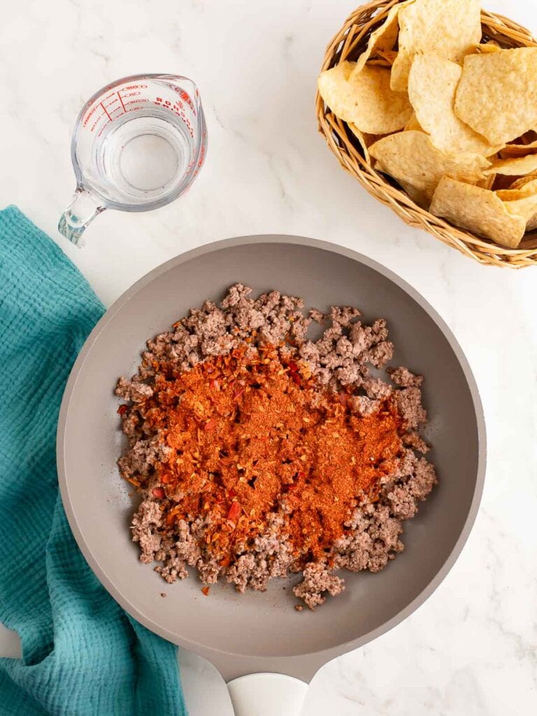 Ground beef and taco seasoning in a pan.