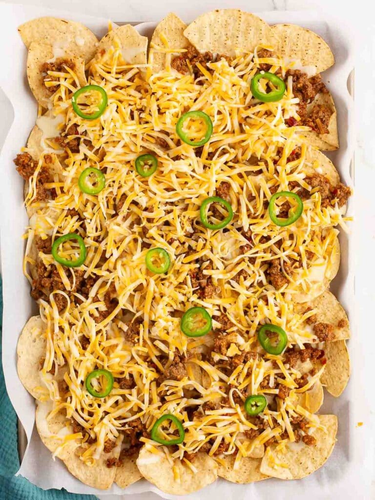 Overhead shot of Beef Nachos in a tray with all the toppings.