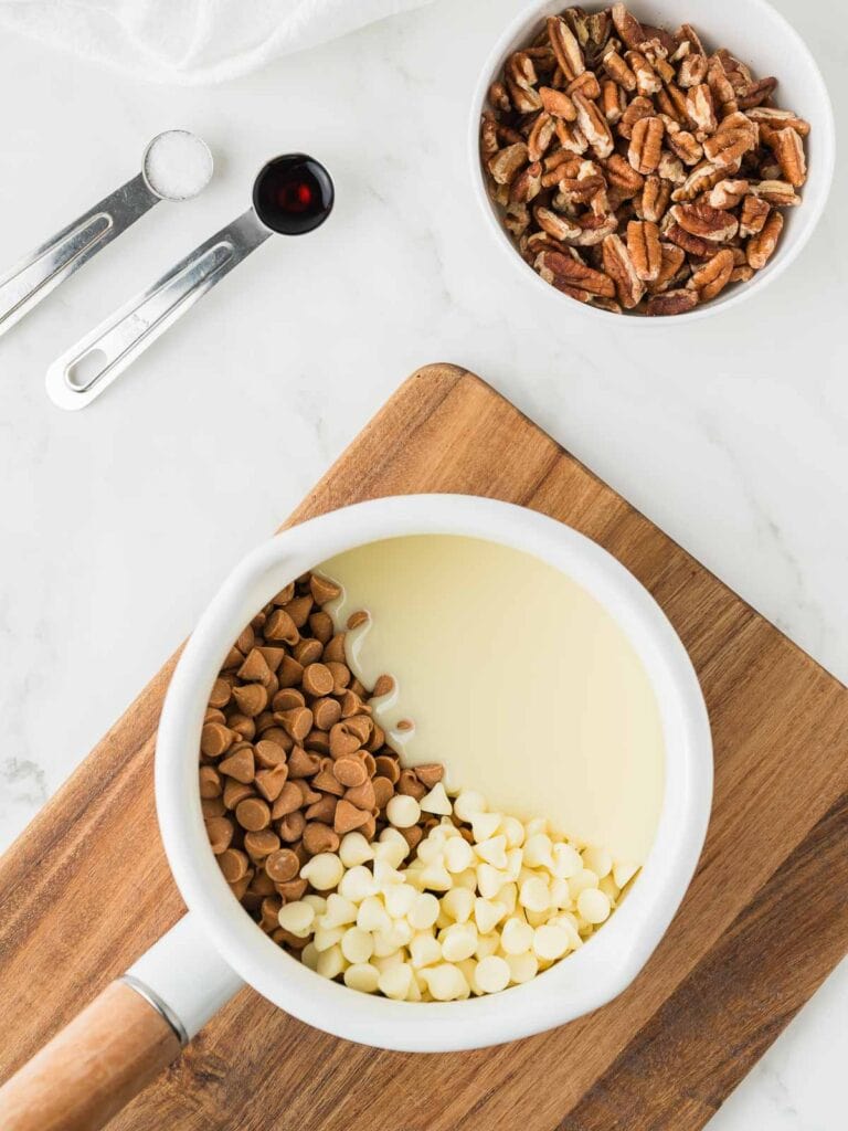 Ingredients for butterscotch pecan fudge in a pot.