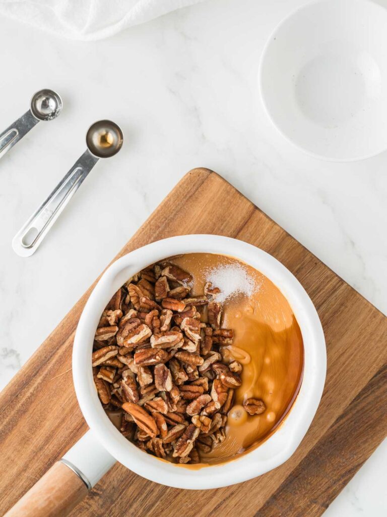 Ingredients for butterscotch pecan fudge in a pot.