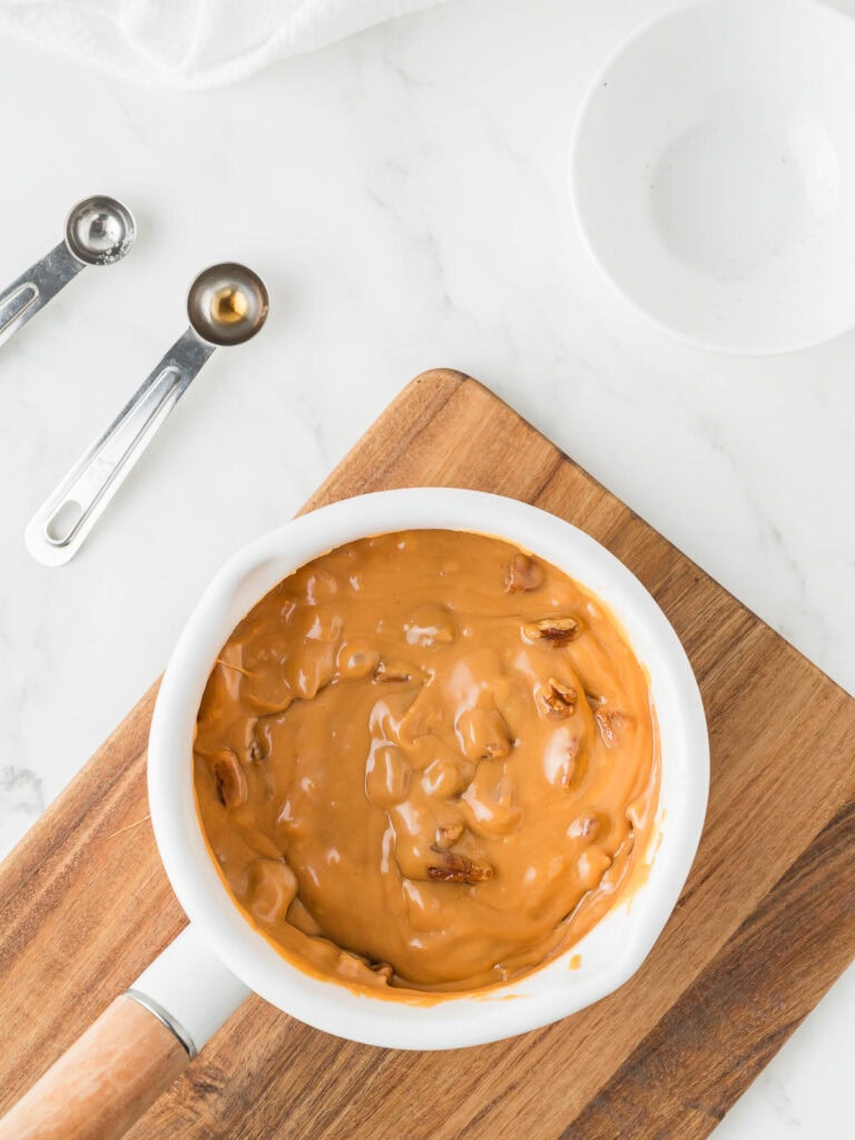 Melted ingredients for butterscotch pecan fudge in a pot.