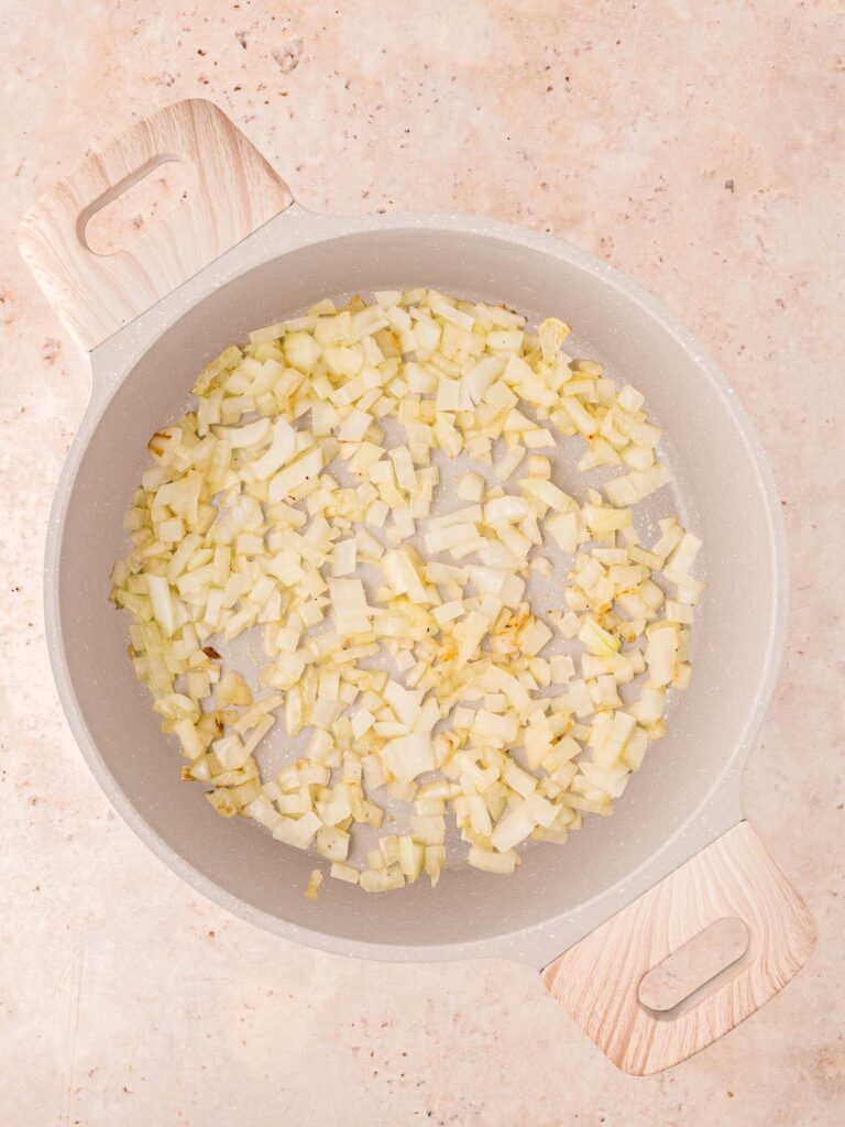 Onions frying in a pot.