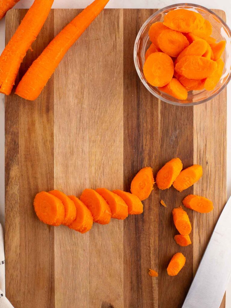 Sliced Carrots on a wooden board.