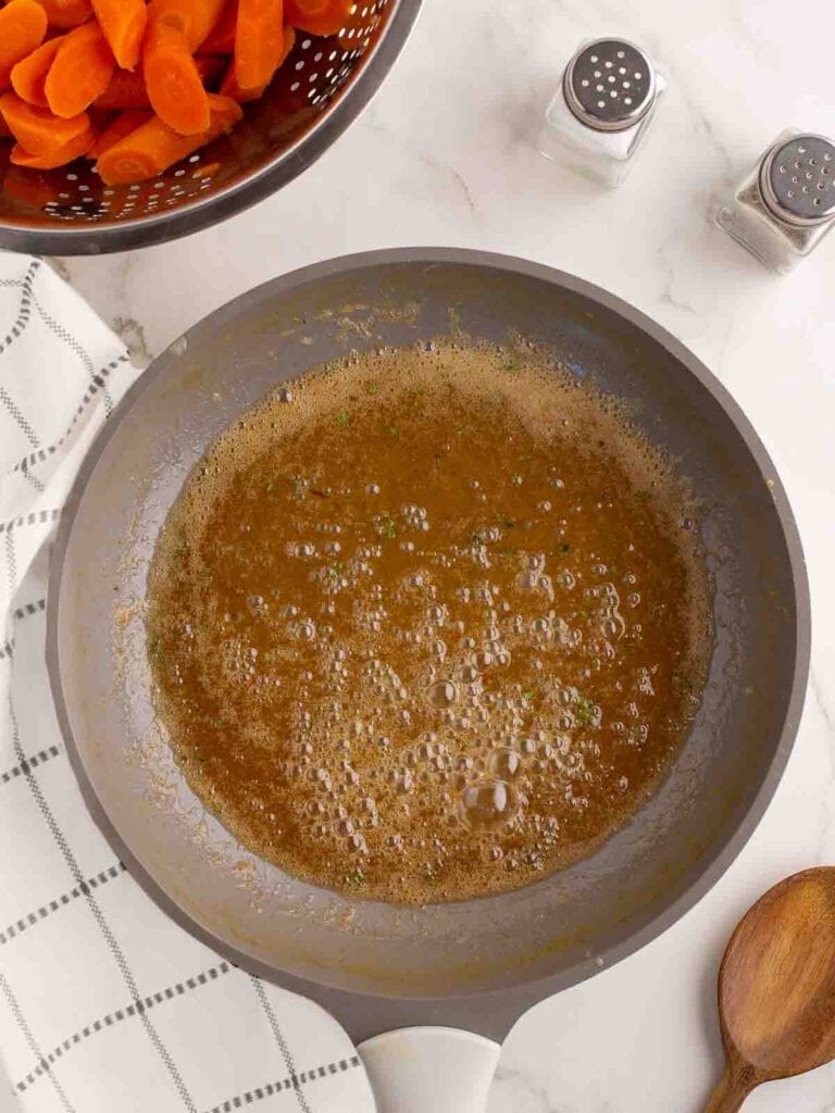 Butter and honey cooking in a skillet