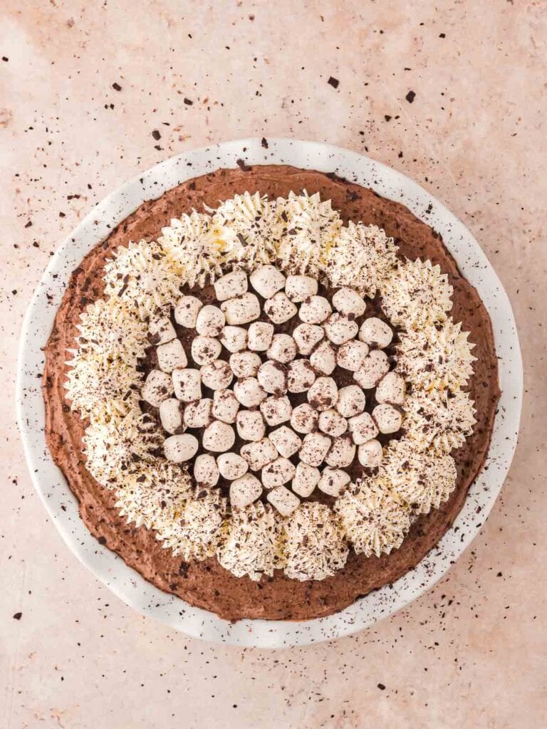 The finished Hot Chocolate Pie with whipped cream , mini marshmallows and chocolate shavings.