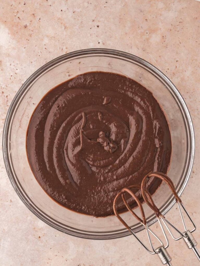 Mixing chocolate pudding in a bowl.