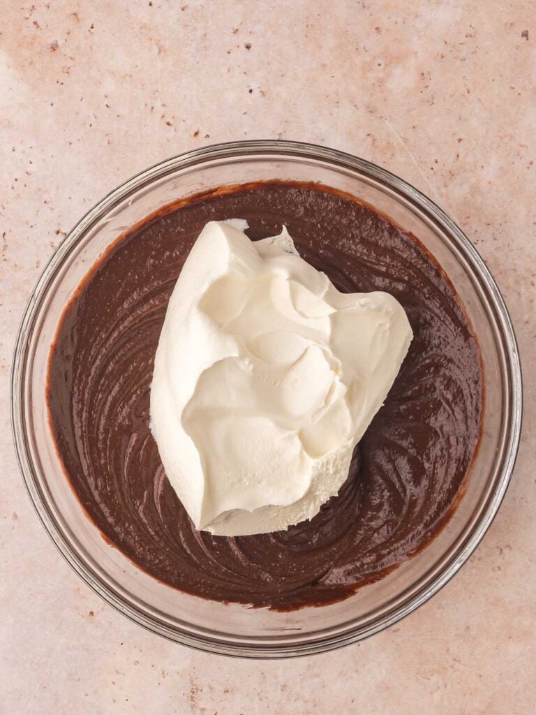 Mixing cool whip into the chocolate mixture.