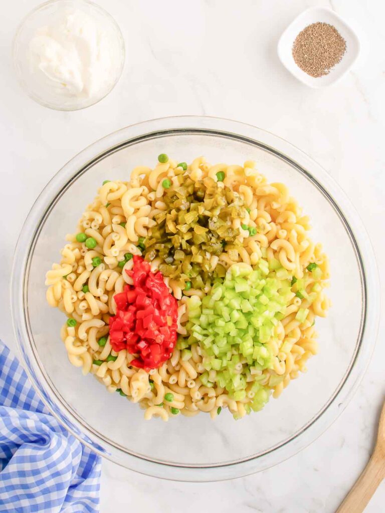 Cooked pasta with veggies on top before mixing.