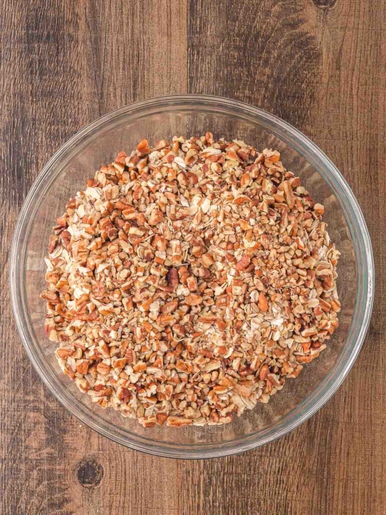 Oats and chopped pecans in a large bowl.