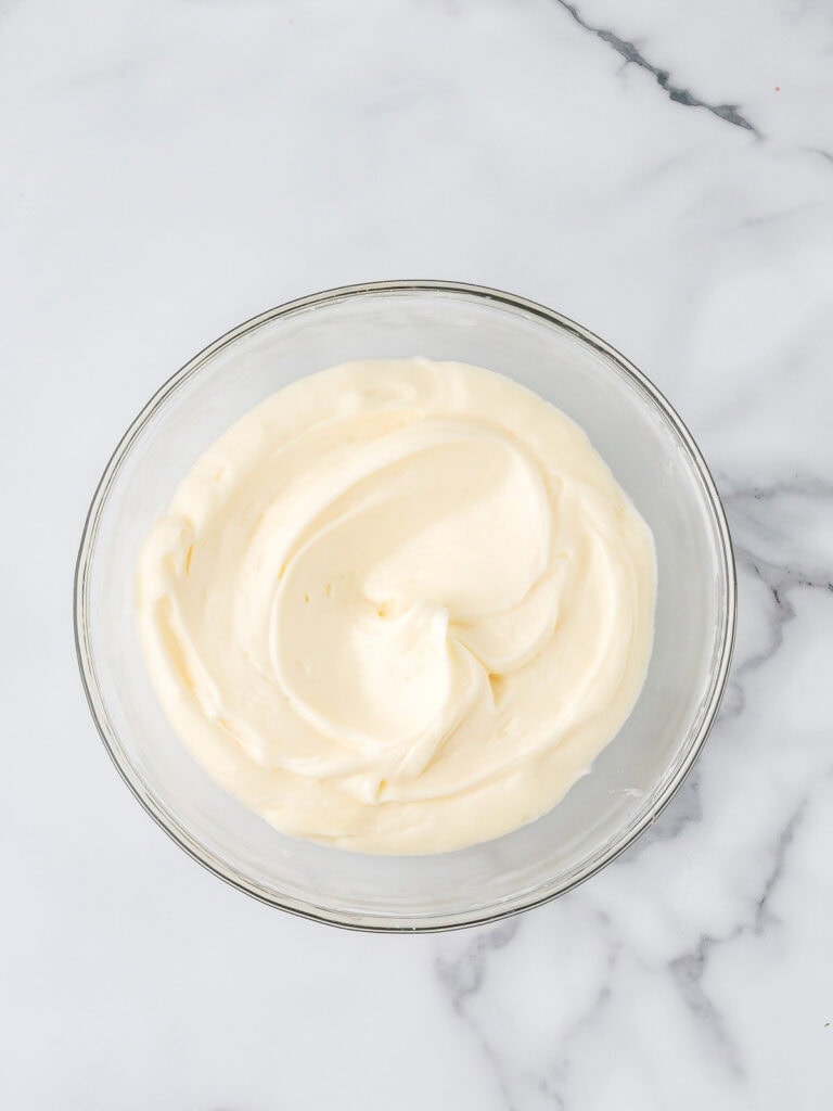 The cream cheese frosting in a bowl.