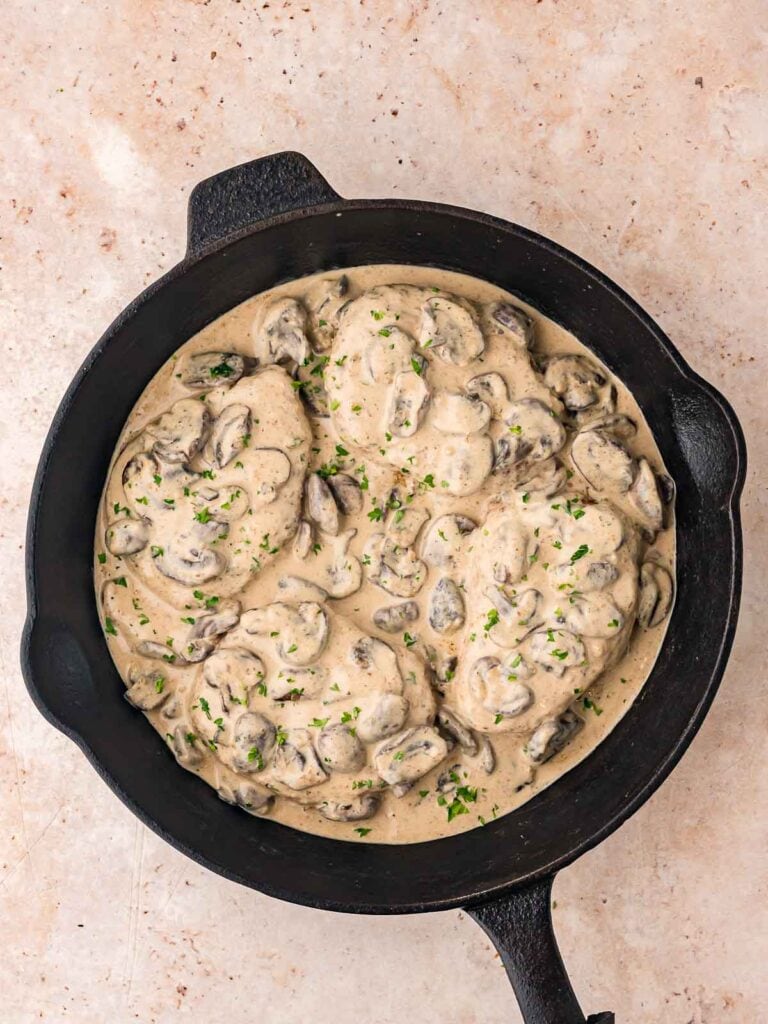 Smothered Pork Chops in a cast Iron pan.