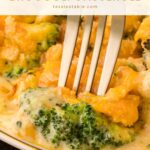Fork digging into a serving of Southern Broccoli Casserole with tender broccoli and melted cheddar by Tessie's Table.