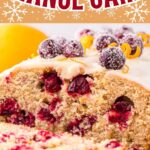 Cranberry orange cake with glaze on a cake stand.