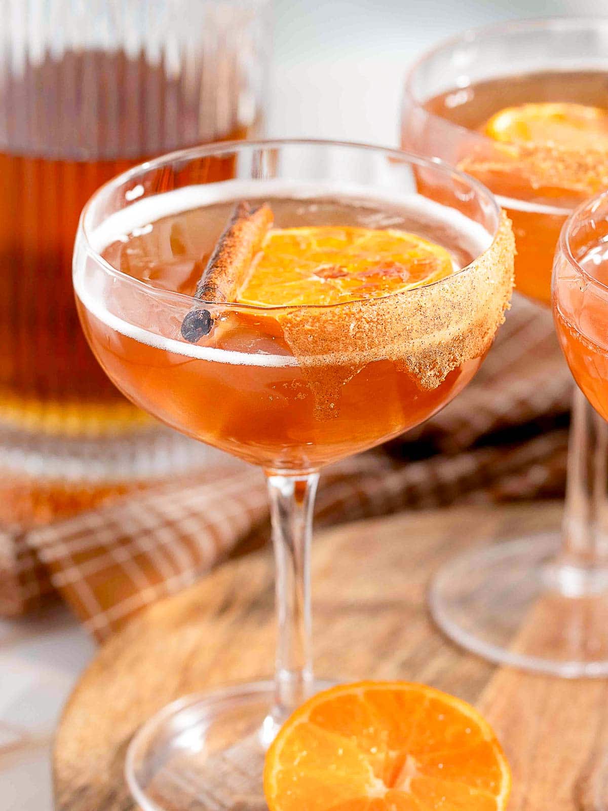 Orange Cinnamon Old Fashioned on a wooden tray.