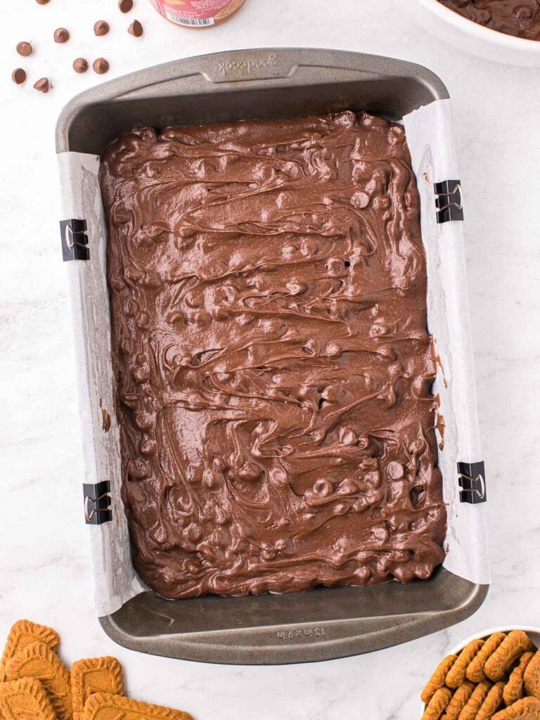 Half of the Biscoff Brownie batter poured into a 9x13 pan.