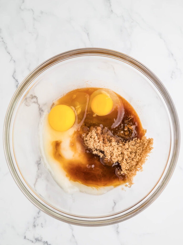 Wet ingredients and brown sugar in a bowl.