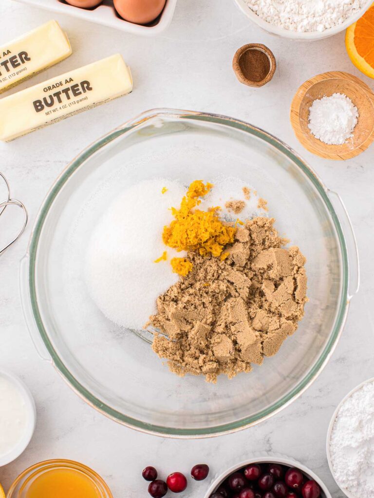 Sugars and orange zest in a bowl.