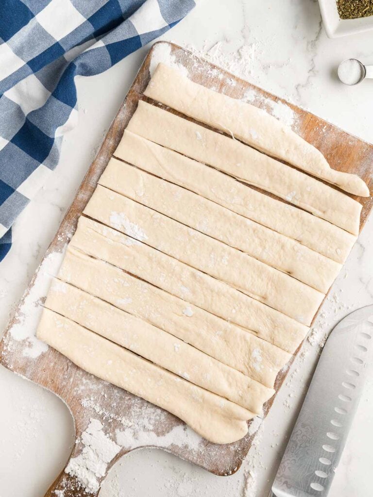 Dough rolled out and cut into 9 pieces.