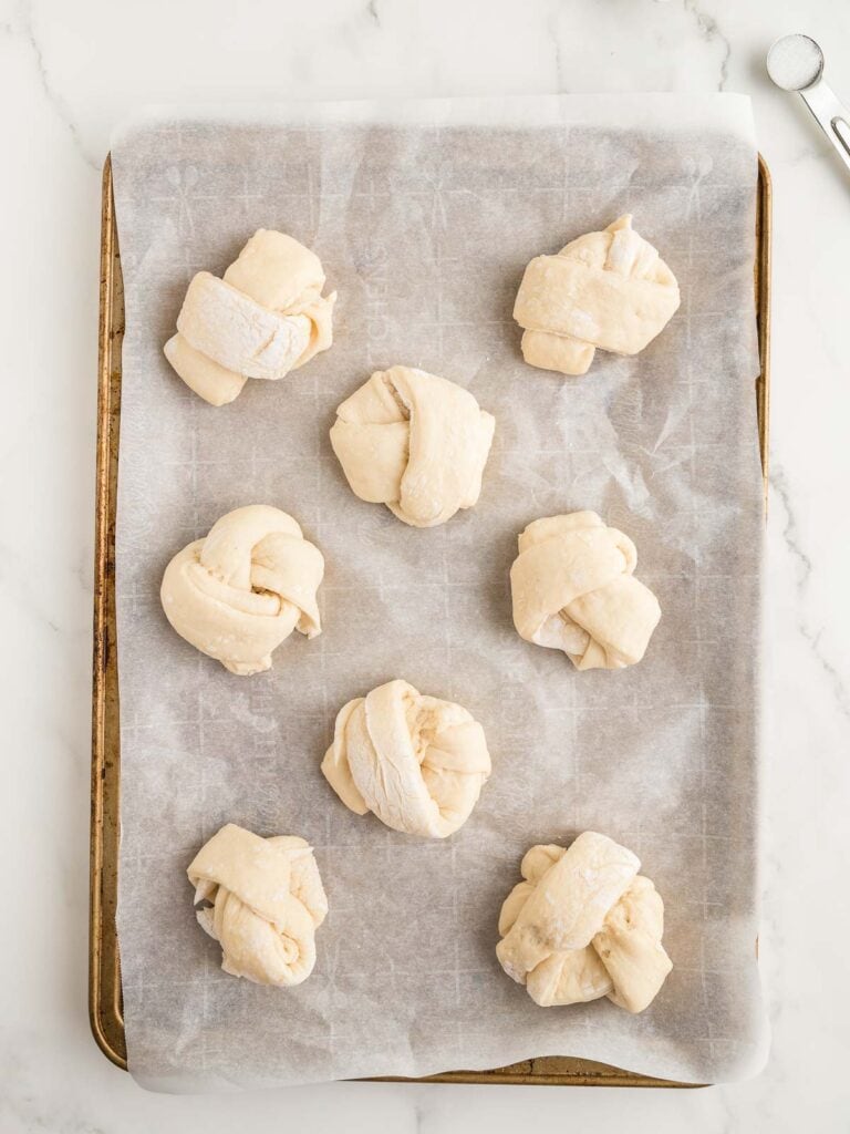 Homemade Garlic Knots on a baking tray.