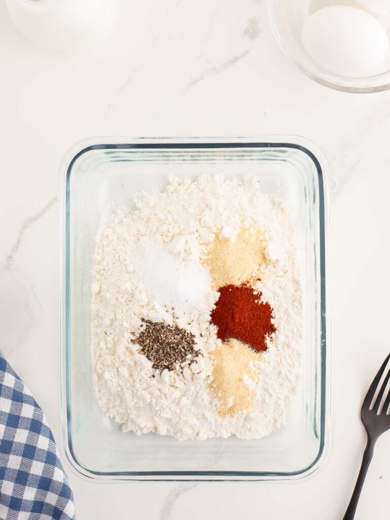 All the dry dredging ingredients in a shallow glass dish.