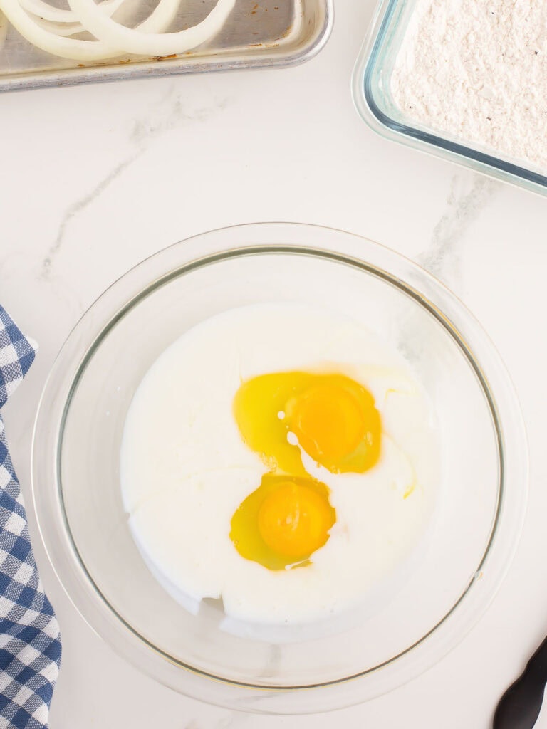 Eggs and buttermilk in a bowl.