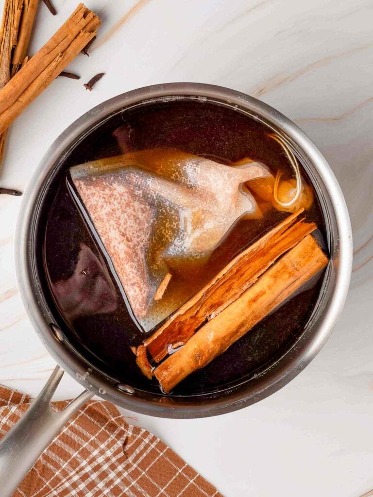 The spices to make the simple syrup in a pot.